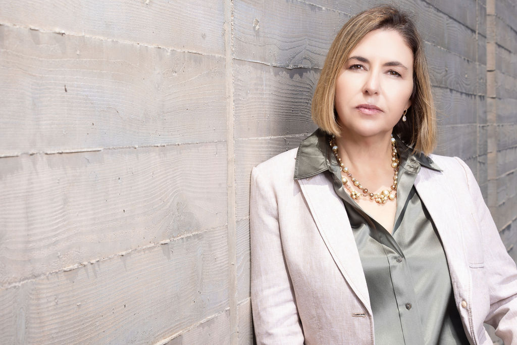 Ingrid Rainey, Managing Partner of Rainey Law P.C., photographed against a weathered wall